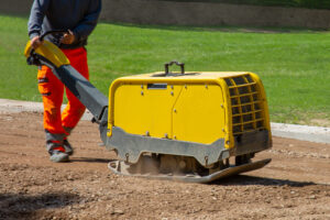 construction-worker-working-road-with-vibratory-plate (1)