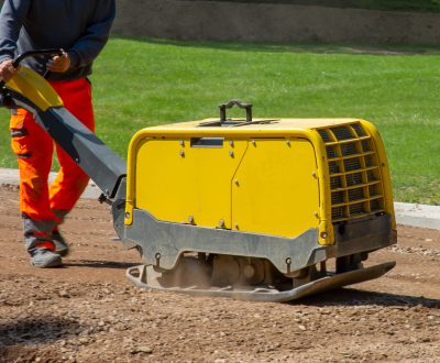construction-worker-working-road-with-vibratory-plate (1) construction-worker-working-road-with-vibratory-plate (1)